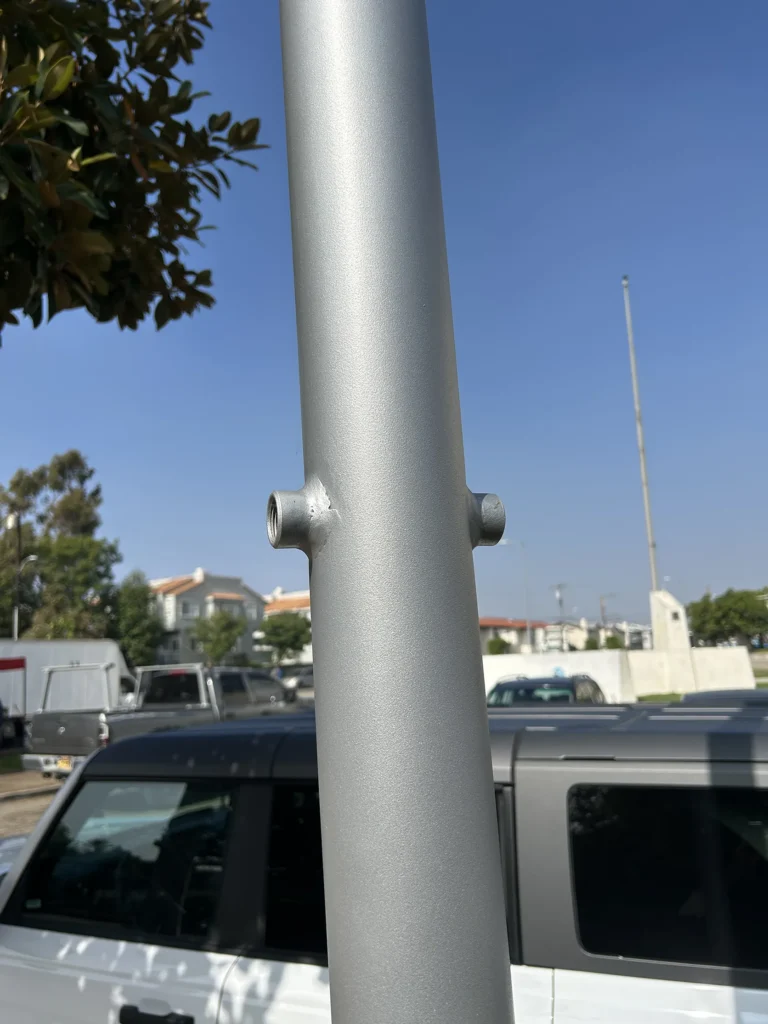 Threaded coupling welded to a light pole for custom equipment mounting